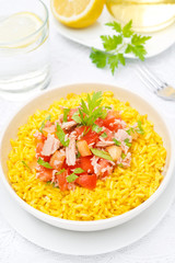 saffron rice with tuna, tomatoes, peppers and herbs, top view