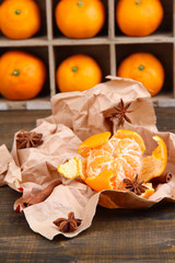 Ripe sweet tangerines in wooden box,on wooden background,