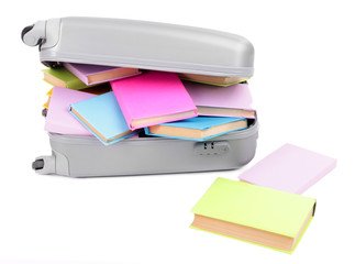 Suitcase with books isolated on white