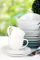 Clean dishes on table on natural background