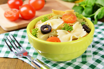 Delicious pasta with tomatoes on plate on table close-up