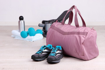 Sports bag with sports equipment in gymnasium