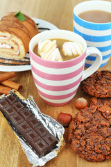 Cup of cappuccino and sweets close up
