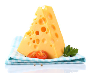 Piece of cheese and tomatoes,on color napkin, isolated on white
