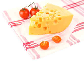 Piece of cheese and tomatoes,on color napkin, isolated on white