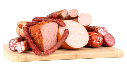 Lot of different sausages on wooden board isolated on white