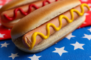 Tasty hot dogs on napkin with stars
