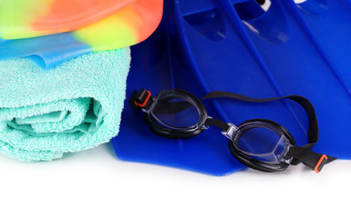 Pool cap, goggles, flippers and towel close-up isolated on