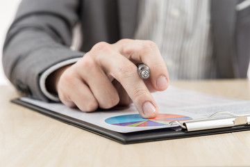 Businessman's hand showing financial report