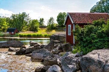 Red wooden buildings and granite stones