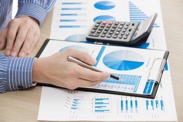 man hand with pen and business report