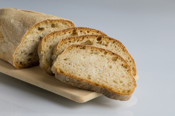 Fresh bread sliced ​​on cutting board in plain sight