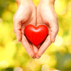 Fototapeta na wymiar Red heart in human hands