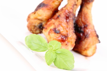 Fried chicken legs decorated with basil