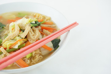 Egg noodle and clear soup vegetarian with chopsticks