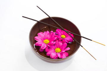 Tibetan bowl, incense sticks and flowers in oil.