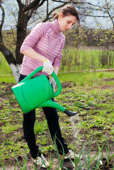 Young woman with onion at garden - Garden works