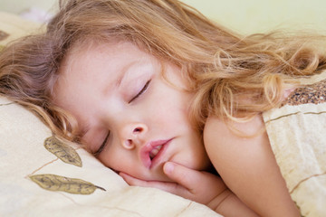 Adorable toddler girl in bed