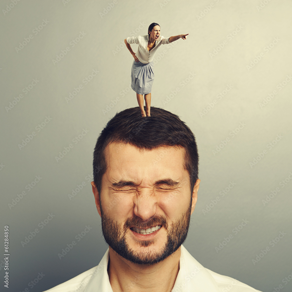 Canvas Prints woman standing on the head of dissatisfied man