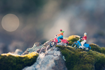 Couple traveling through the countryside on vintage motorcycles