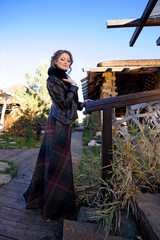 Portrait of a young girl in a black long dress on the street
