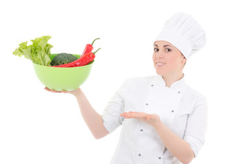 young attractive cook woman in uniform with vegetables isolated