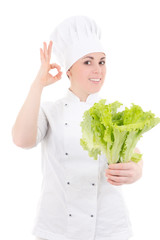 young attractive cook woman in uniform with fresh salad showing