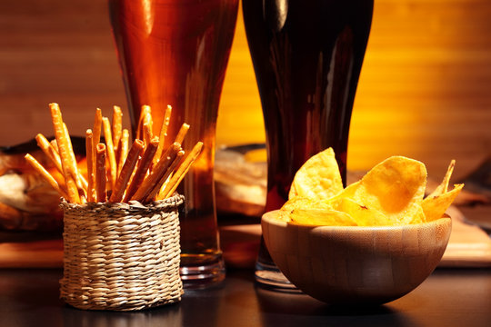 Glasses of  beer with chips and snacks