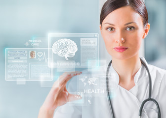 Calm doctor touching a medical interface in the hospital