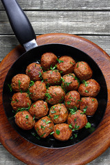 Fried pork meatballs in frying pan