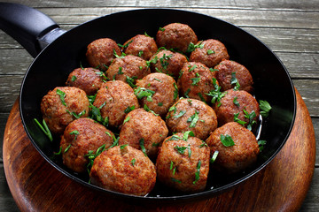 Fried pork meatballs in frying pan