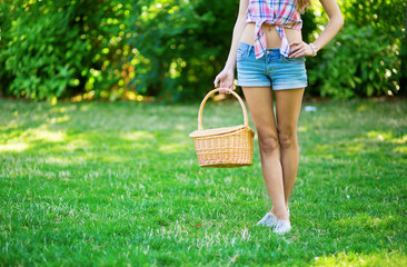 Young girl holding a picnic basket