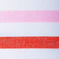 Closeup of red pink white striped textile background texture