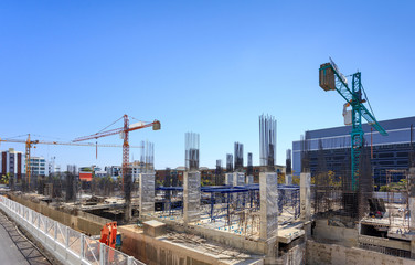 Building crane and construction site under   blue sky