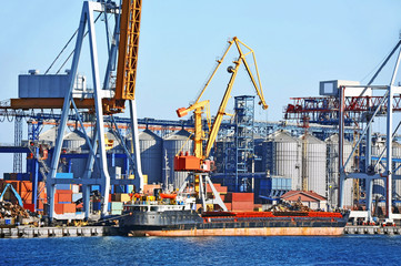 Fototapeta premium Bulk cargo ship under port crane bridge, Odessa, Ukraine