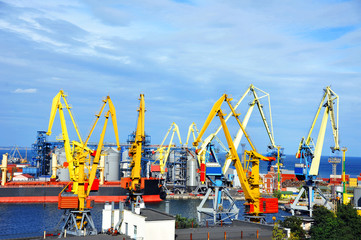 Bulk cargo ship under port crane bridge, Odessa, Ukraine