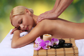 Spa Massage. Beautiful Blonde Woman Getting Body Massage.