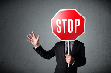 Businessman holding a stop sign