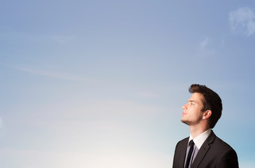 Handsome man looking at the blue sky copyspace