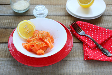 slices salty salmon fillet and lemon