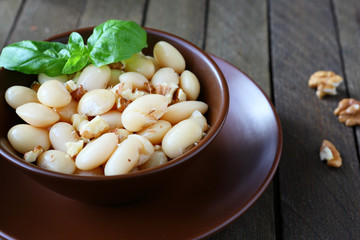 side dish of white beans with nuts