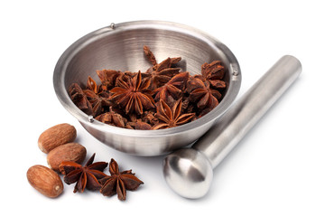 Mortar and pestle with anise stars and nutmeg