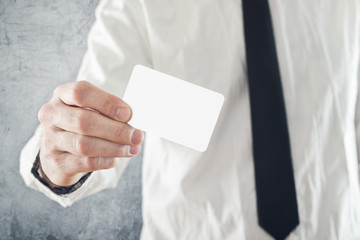 Businessman holding blank credit card