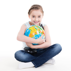 Portrait of a cute little girl with a globe.