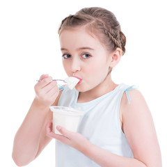 Portrait of a  little girl eating yogurt.