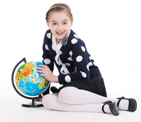 Portrait of a cute little girl with a globe.