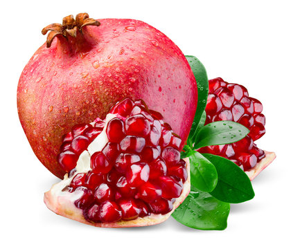 Juicy pomegranate and its piece with leaves. Isolated on a white