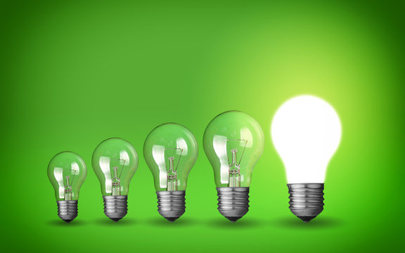 Row of light bulbs.Idea concept on green background.