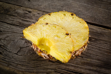 Pineapple. Slices on wood. Organic fruit