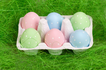 pastel colored easter eggs in cardboard